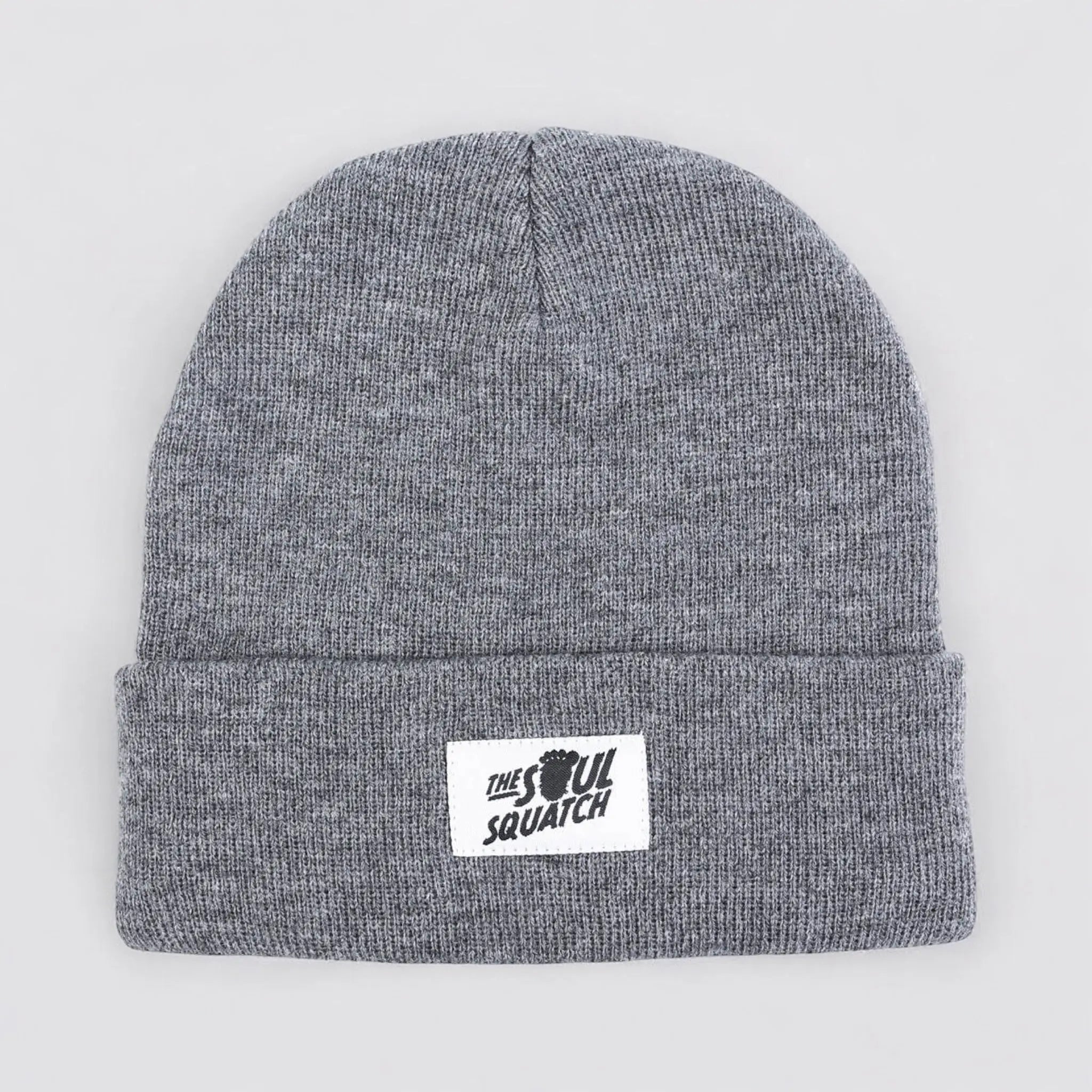 Flat lay of The Sasquatch Soul Beanie in Foggy Fir Gray — soft knit beanie with a cuffed edge and Soul Squatch patch logo.