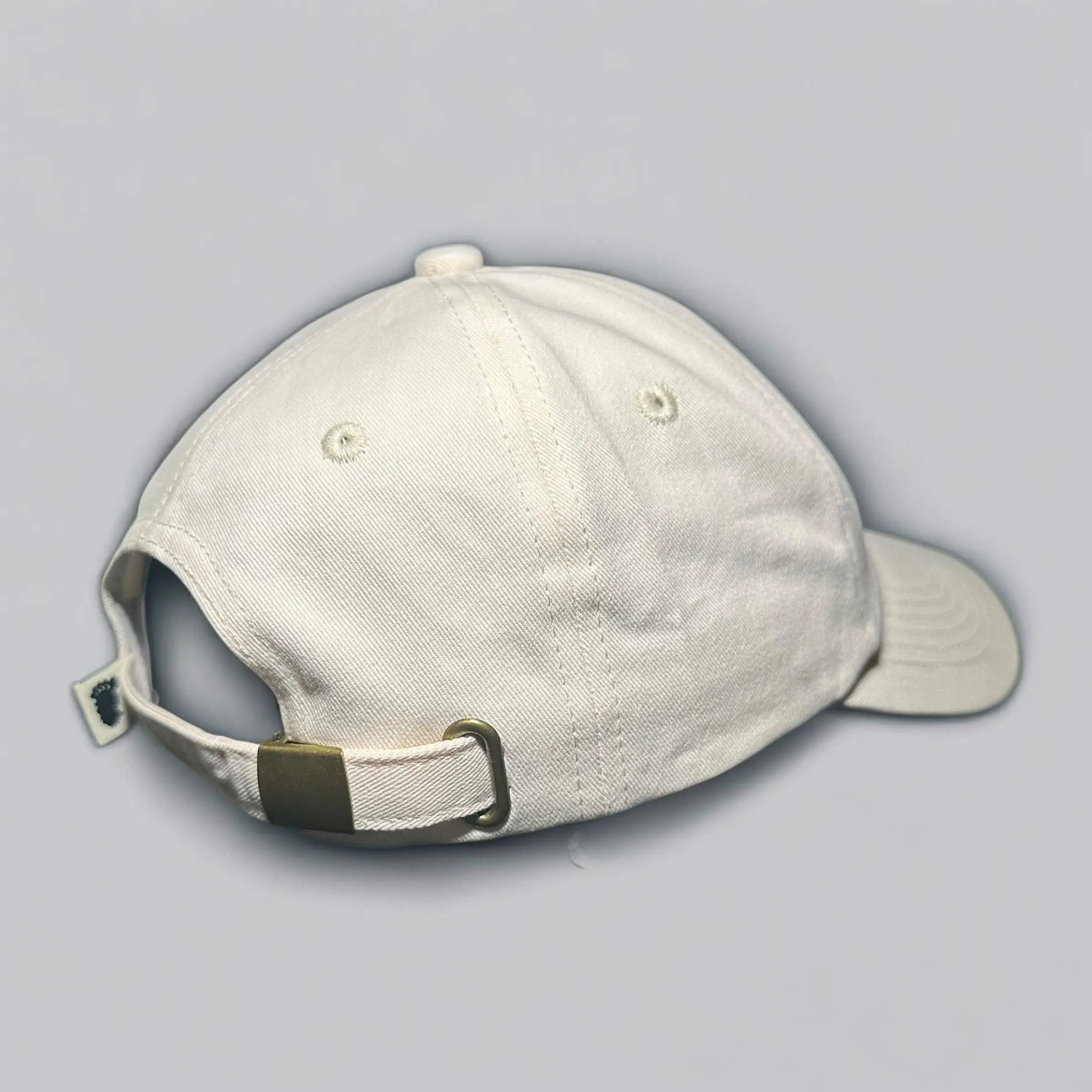 Side and back view of the beige Sandstone Trail Dad Hat showing off its curved brim, soft crown, and adjustable strap with brass buckle. A sustainable staple for off-grid adventures and everyday wear.