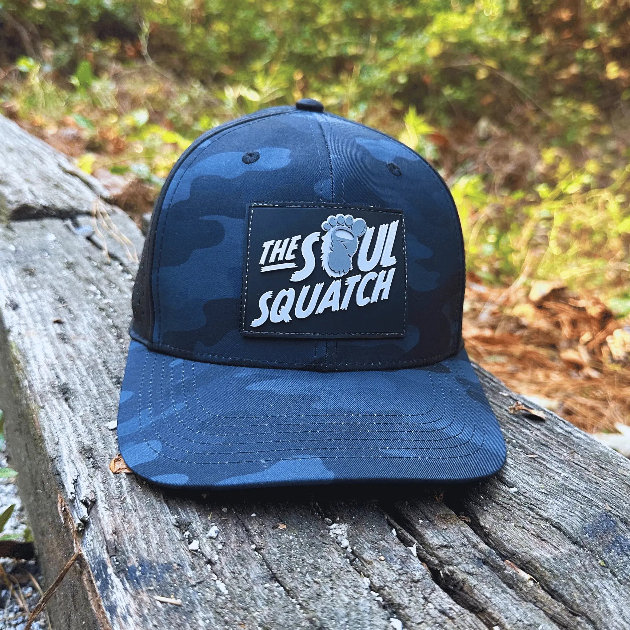 Dark Camo Pathfinder Mid-Profile  Hat spotted in the wild on a forest log – built for adventurous souls trekking off the grid.