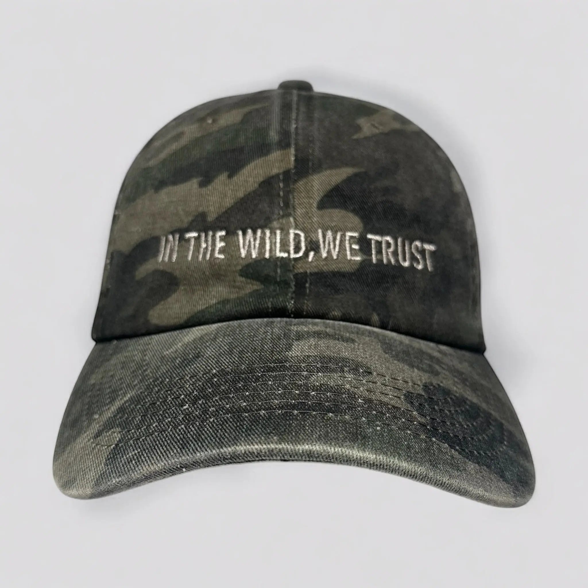 The Soul Squatch, Low-profile camo dad hat with ‘In The Wild We Trust’ embroidered on front; rugged outdoors headwear for adventurers, hikers, and Bigfoot believers.