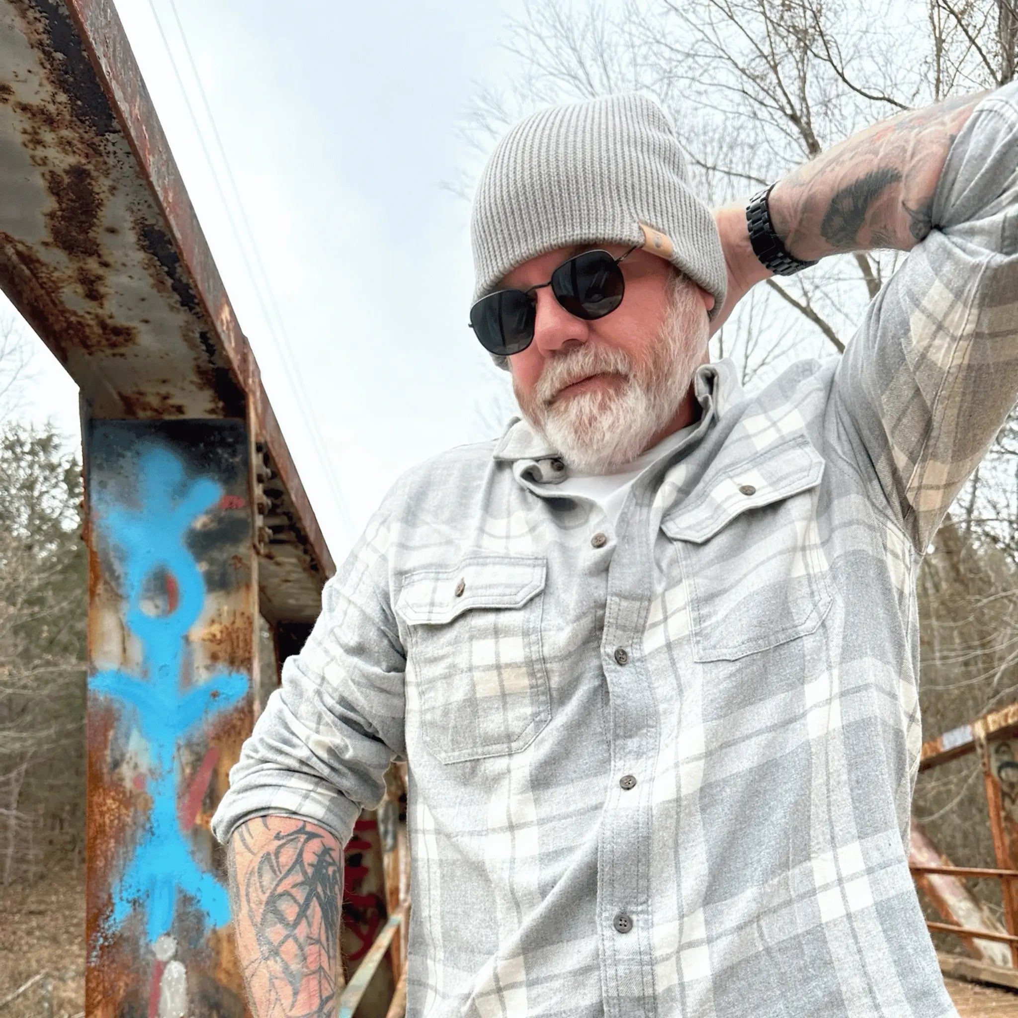 Man wearing the Stone Giant Gray, Wilderness Wanderer Beanie — classic gray knit beanie with leather Bigfoot footprint patch, perfect for everyday adventures and cold mornings.