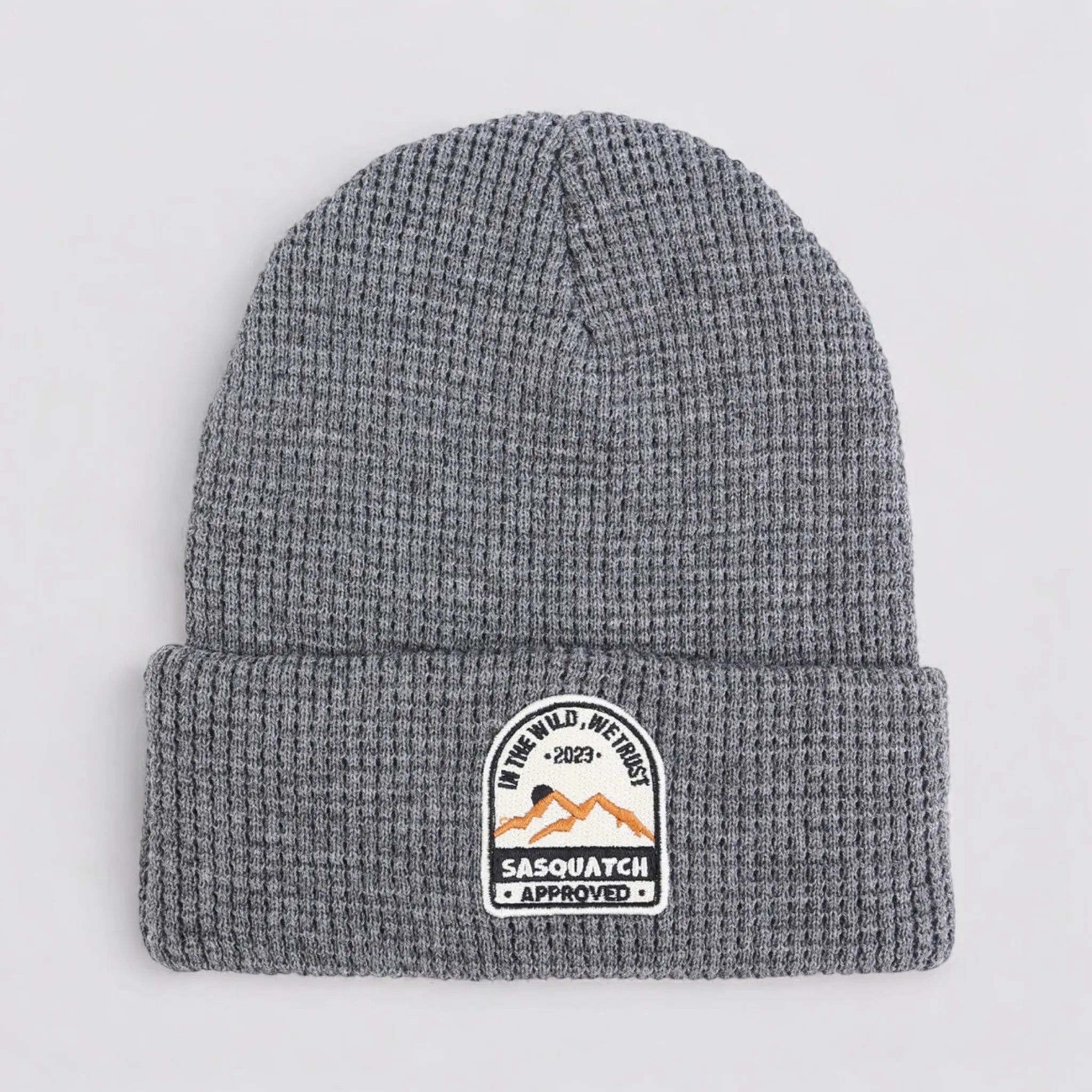 Flat lay of the Sunrise Summit Beanie in Mountain Peak Gray — gray waffle-knit beanie with Sasquatch-approved mountain patch.