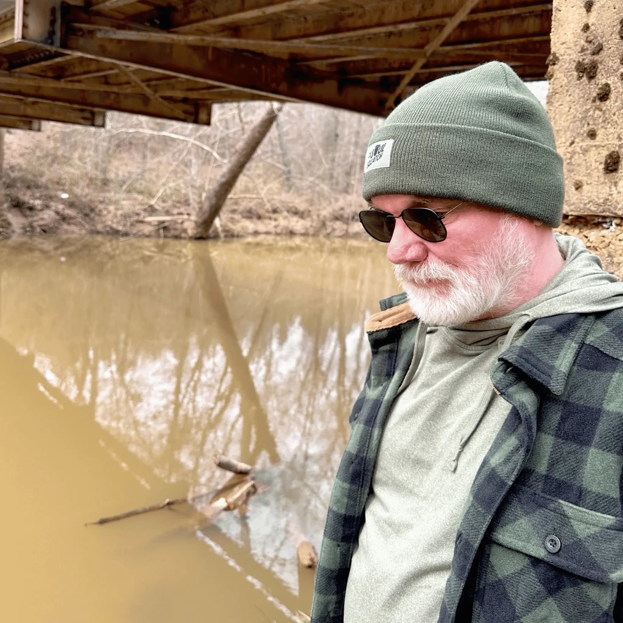 Man wearing the Deep Forest Green, Sasquatch Soul Beanie — rugged green beanie with The Soul Squatch patch, designed for forest explorers.