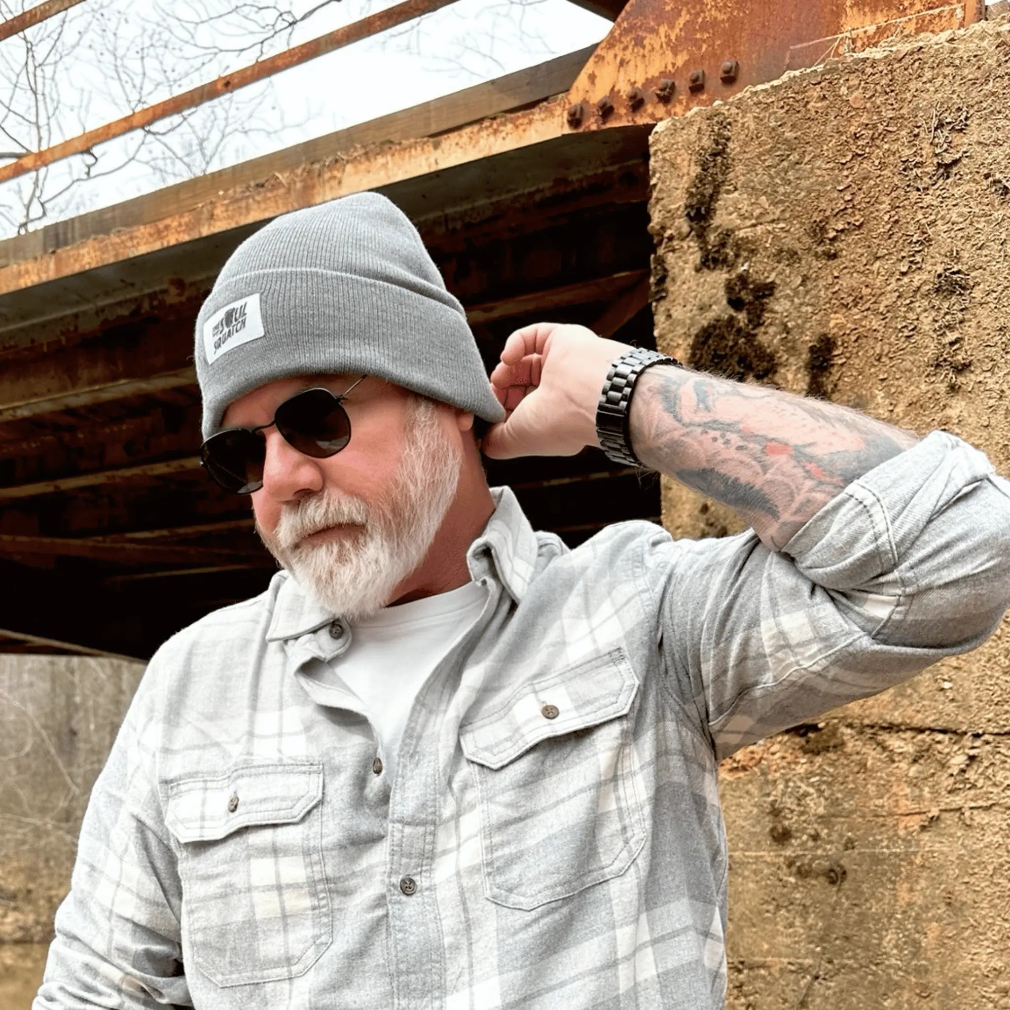 Man wearing the Sasquatch Soul Beanie in Foggy Fir Gray  color— outdoor-ready knit hat with logo patch, designed for cool-weather adventures.