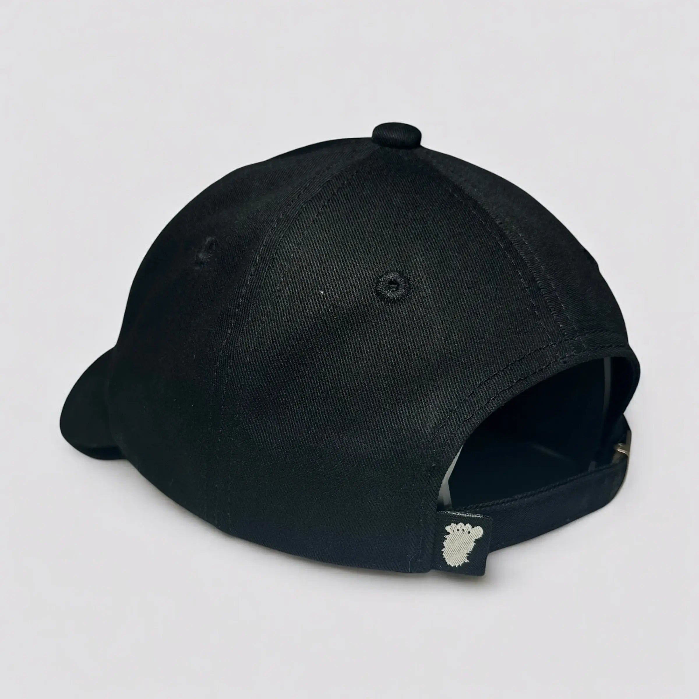 Angled view of the Stealth Pine Dad Hat in black highlighting the curved brim, soft 6-panel crown, and breathable construction. Designed for outdoor enthusiasts seeking a rugged, eco-friendly fit.