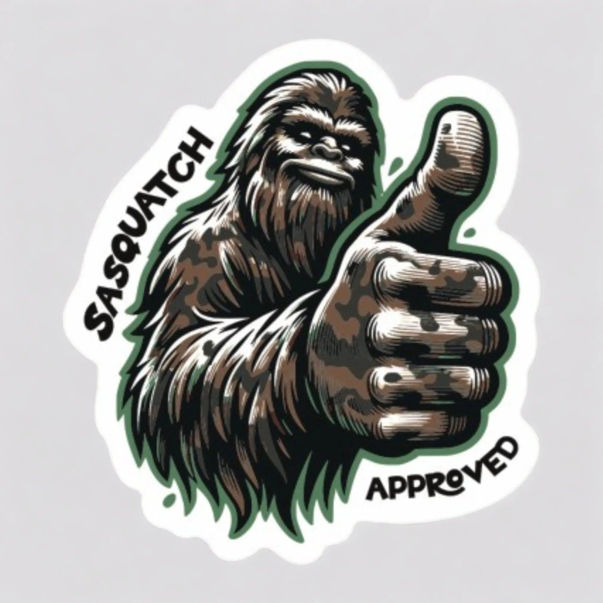 Flat lay of the Squatch Approved Sticker — 2.73x3” vinyl decal featuring a Bigfoot giving a thumbs-up with “Sasquatch Approved” lettering.