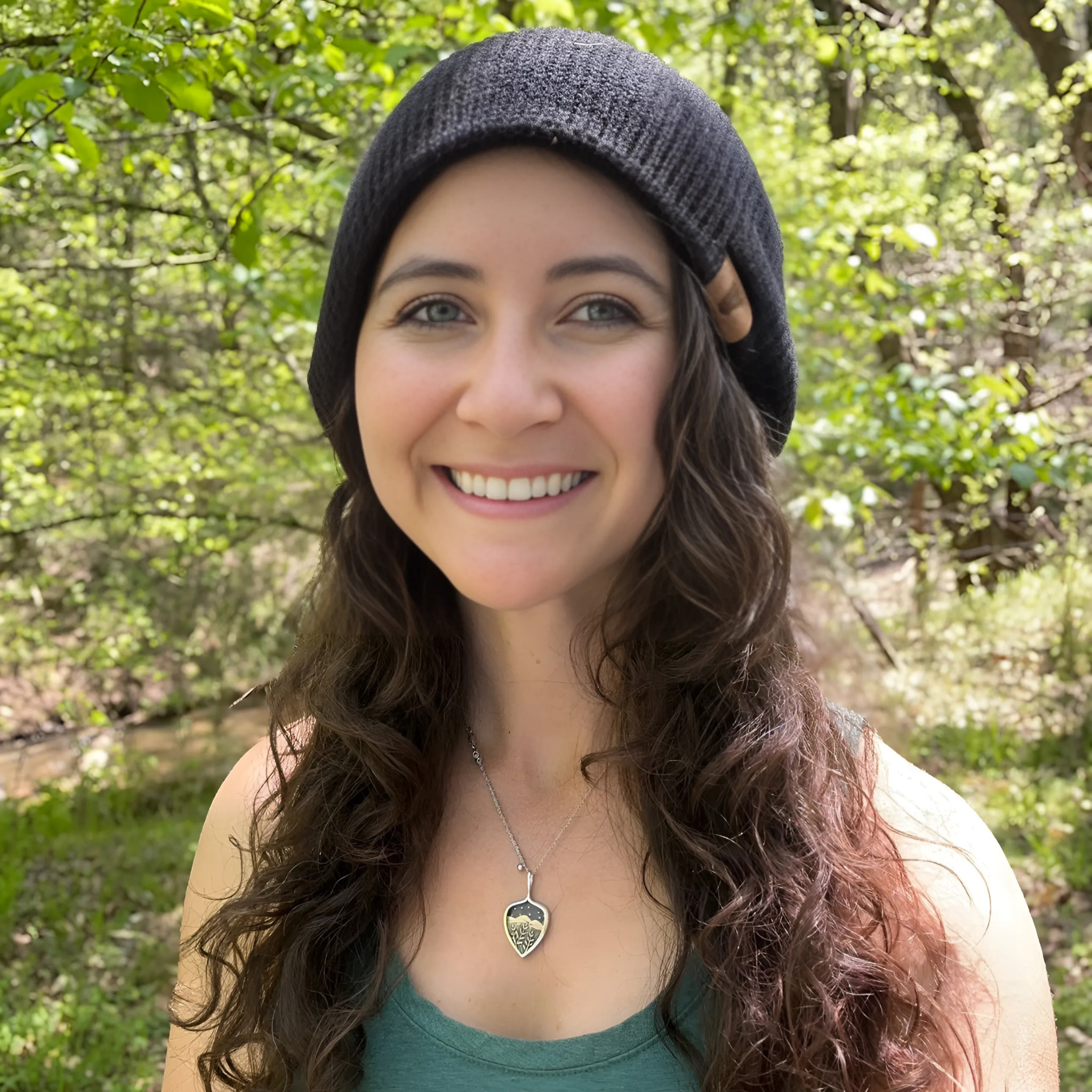 Woman wearing The Soul Squatch Wilderness Wander Beanie in black — knit beanie for wild-hearted hikers and Bigfoot seekers.